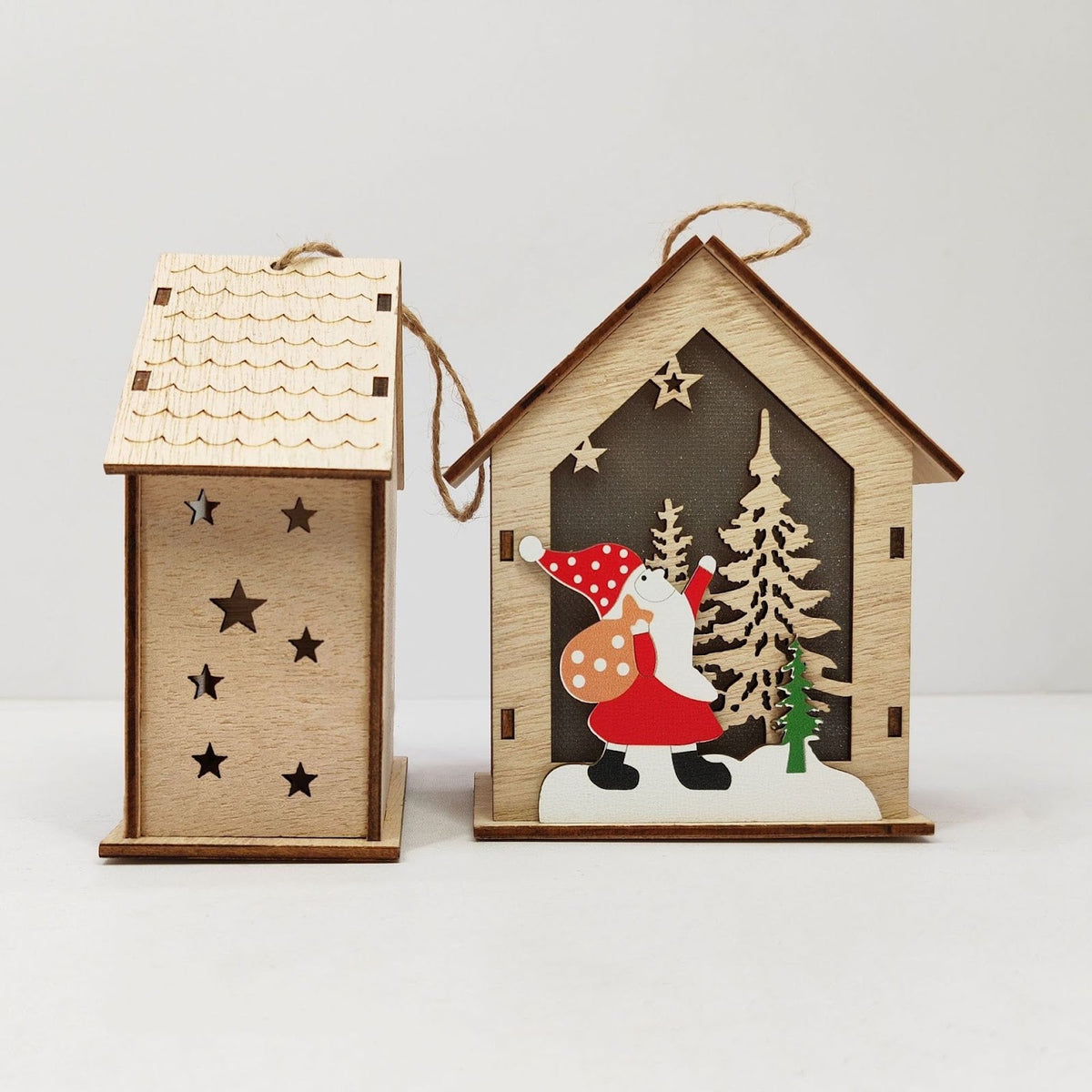 Illuminated wooden Christmas house as tree ornament