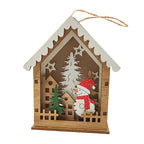 Illuminated wooden Christmas house as tree ornament