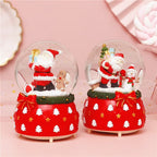 Illuminated snow globe music box, resin