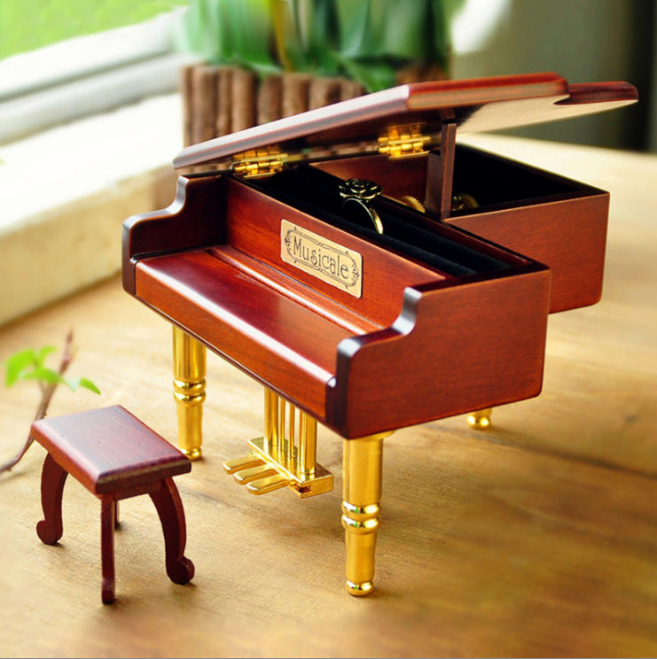 Wooden music box in piano shape with metal feet