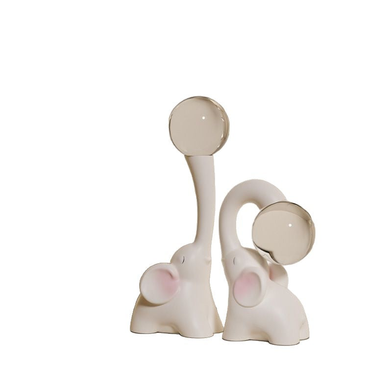 Decorative elephant figure with snow globe