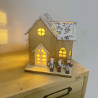 Illuminated Wooden Christmas House with Snow Landscape