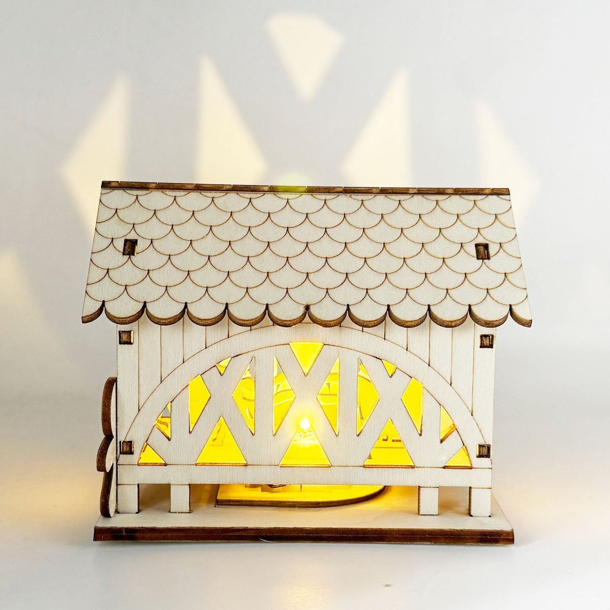 Illuminated wooden house with bridge