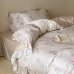 Luxurious satin bedding set with delicate rose pattern and ruffled hem