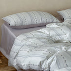 Cotton percale bed linen set with subtle floral stripe pattern and reversible material
