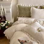 Quilted bedding set with ruffled hem and tone-on-tone embroidery