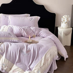 Luxurious bedding set with embroidered feather motifs and quilted bedspread
