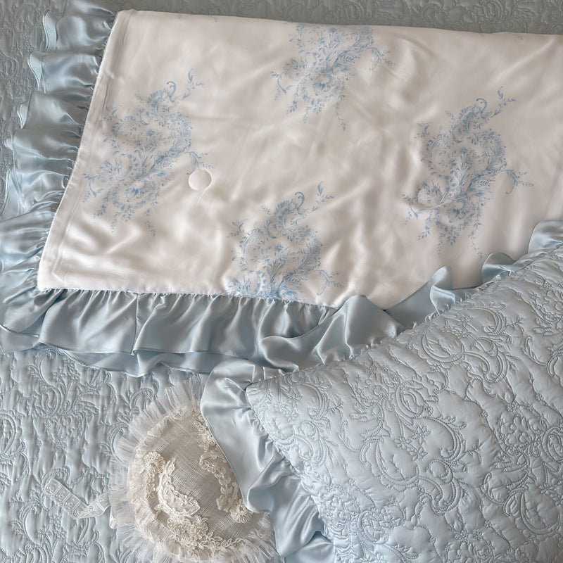 Quilted bedspread with ruffle and reversible satin bedding set