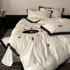 Luxurious satin bedding set with black lace trim and embroidered rose appliqués