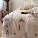 Bedding set made of linen look with floral embroidery and bow closure