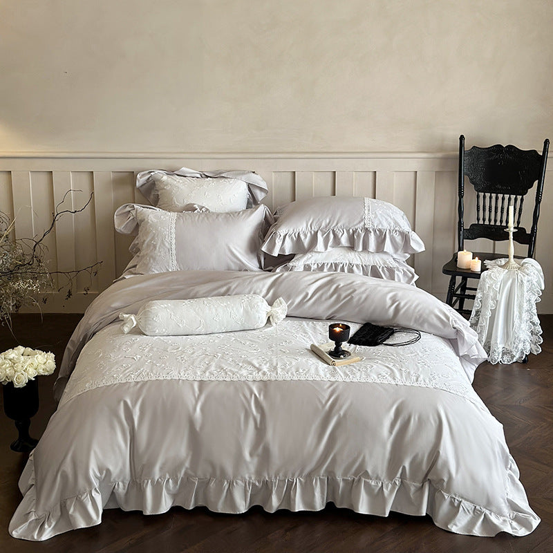 Luxurious satin bedding set with ruffles, lace trim, and fine embroidery