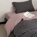 Reversible bedding set made of cotton satin with a fine floral allover, contrasted inside and decorative ribbons.