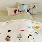 Children's bedding set with appliquéd winter figures and checkered ruffle