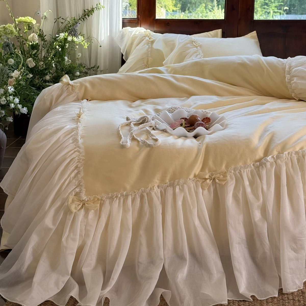 Bedding set with ruffled bed skirt, ruffle cushion and bow application