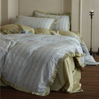 Bedding set with fine striped texture, ruffled border and breathable cotton blend