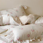 Luxurious satin bedding set with delicate rose pattern and ruffled hem