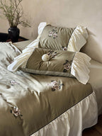 Luxurious satin bedding set with floral embroidery and frills