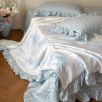 Quilted bedspread with ruffle and reversible satin bedding set