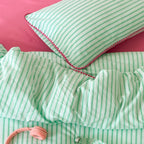 Striped cotton percale bedding set with contrasting decorative piping