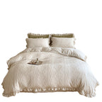 Quilted bedding set with ruffled hem and tone-on-tone embroidery