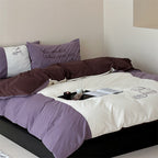 Reversible bedding set with contrasting inserts and fine line embroidery