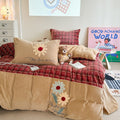 Quilted bedding and throw blanket set with check stitching, velvet texture, and floral appliqué