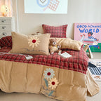 Quilted bedding and throw blanket set with check stitching, velvet texture, and floral appliqué