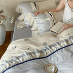Romantic cotton satin bedding set with ruffles, embroidered flower bouquets, and decorative rolls Bowlift
