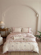Romantic cotton satin bedding set with ruffles, embroidered flower bouquets, and decorative rolls Bowlift
