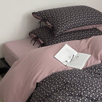 Reversible bedding set made of cotton satin with a fine floral allover, contrasted inside and decorative ribbons.
