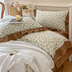 Romantic bed linen complete set made of cotton percale with delicate floral print, ruffle trim, and silky-matte finish