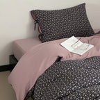 Reversible bedding set made of cotton satin with a fine floral allover, contrasted inside and decorative ribbons.