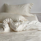 Bedding set made of cotton satin with ruffle, subtle jacquard floral relief and silky-matt finish