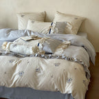 Romantic cotton satin bedding set with ruffles, embroidered flower bouquets, and decorative rolls Bowlift