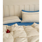 Cotton gauze bedding set with delicate border embroidery and mottled nep structure