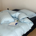Cotton satin bed linen set with contrasting piping and subtle brand embroidery