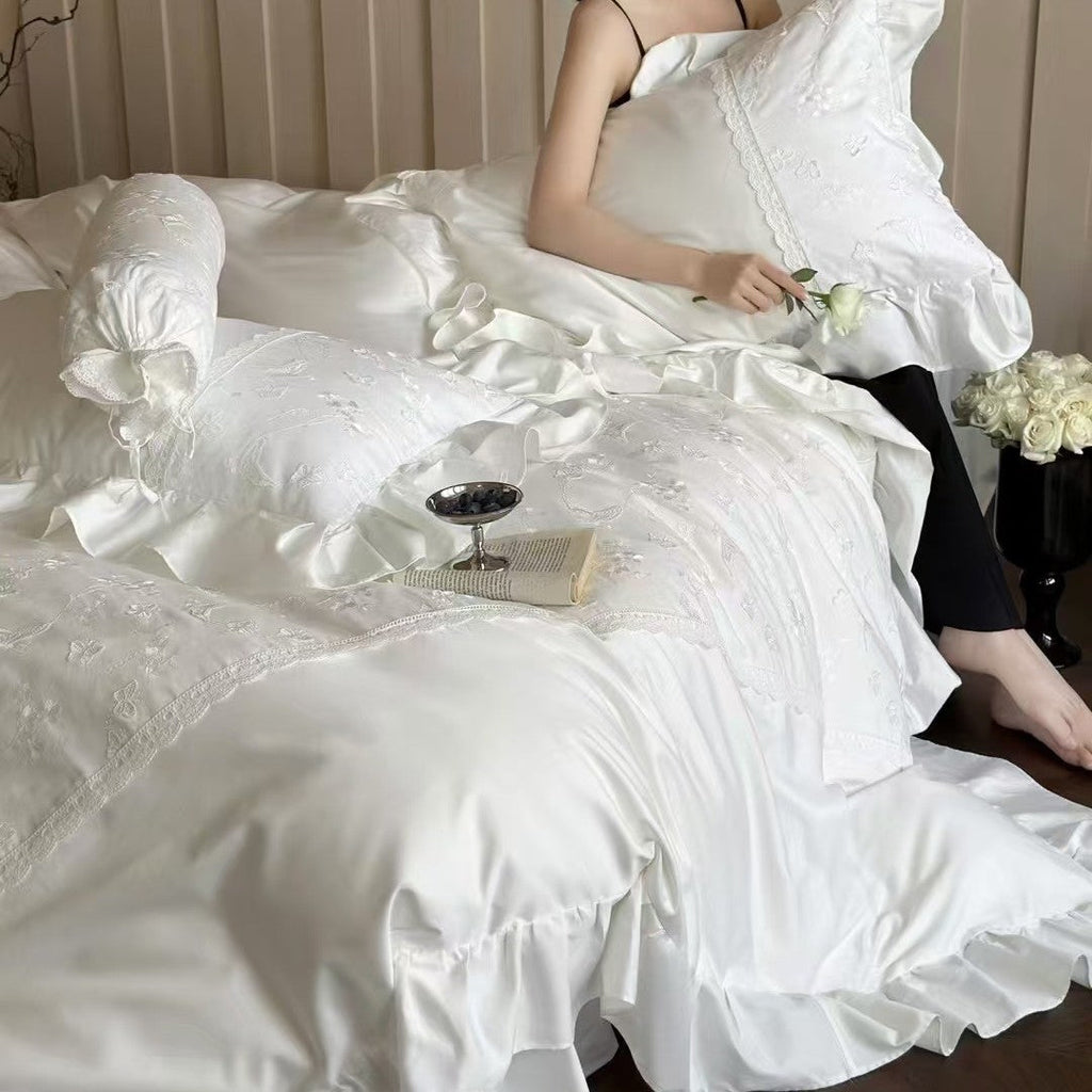 Luxurious satin bedding set with ruffles, lace trim, and fine embroidery