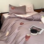 Luxurious cotton satin bedding set with embroidered strawberry appliqués