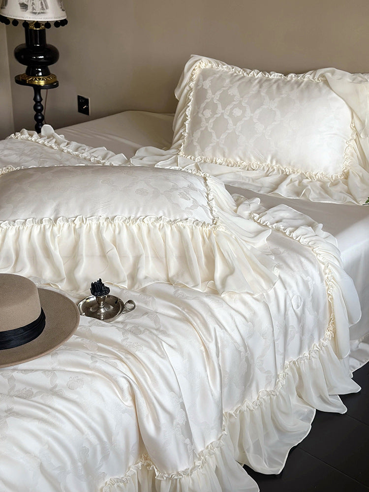 Elegant satin bed linen set with generous ruffle trim and tone-on-tone jacquard pattern