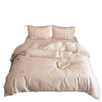 Luxurious satin bedding set with embroidered floral appliqués and bolster Bowlift