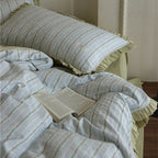 Bedding set with fine striped texture, ruffled border and breathable cotton blend