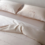 Finely woven cotton bedding set with embroidered animal border