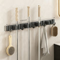 Wall bracket for brooms and mops made of stainless steel